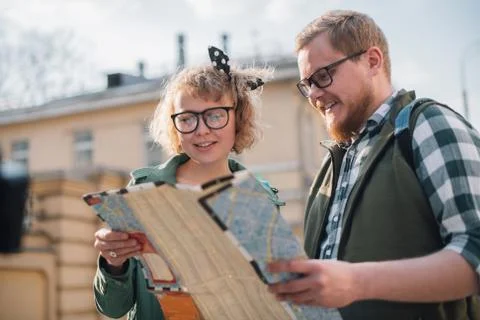 Tourists with a map on the background of the city Stock Photos