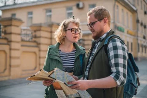 Tourists with a map on the background of the city 写真素材