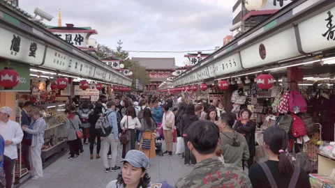 Tourists in the Nakamise shopping street of Sensoji Buddhist temple in Asakusa. Stock Footage