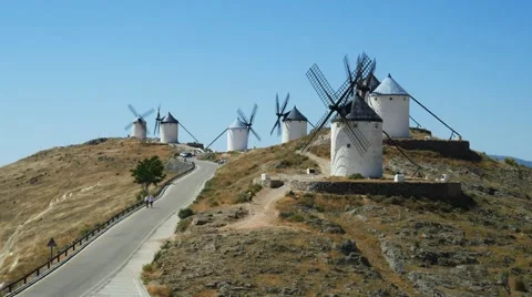 Tourists next to a windmill of Castilla la Mancha, Spain. Windmills at Consuegra Stock Footage 65936634