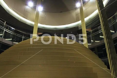 Tourists observe large tuned mass damper in Taipei 101 Stock Photos