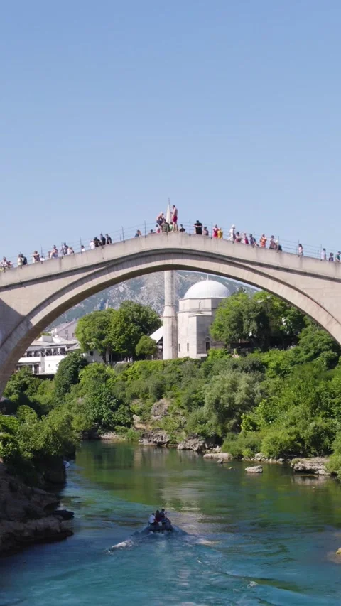 Tourists observing a diver jumping from Stari Most in Mostar, Bosnia and Stock Footage 311160845