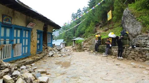 Tourists outside the partially demolished structures of Nepal Stock Footage 77446222