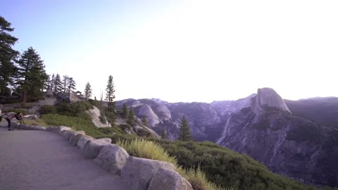 Tourists Overlooking Mountains and Half Dome Rock in Yosemite Stock Footage 146564285