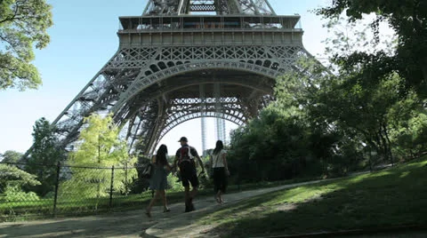 Tourists passing by the base of the Eiffel tower in Paris France. Stock Footage 26838558
