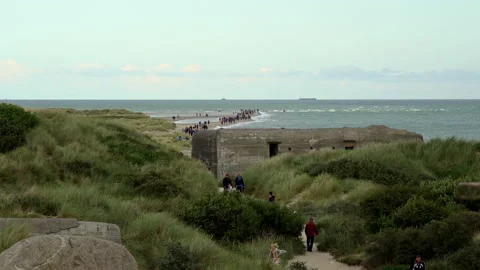 Tourists on the peninsula of Grenen between the Baltic Sea and the North Sea Video stock 162340981