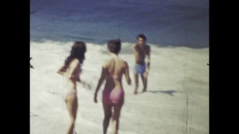 Tourists playing on the beach in rio de janeiro, brazil, in the 1960s Stock Footage 314055074