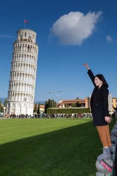 Tourists posing in front of the Leaning Tower of Pisa. Editorial, illustrativ Stock Photos