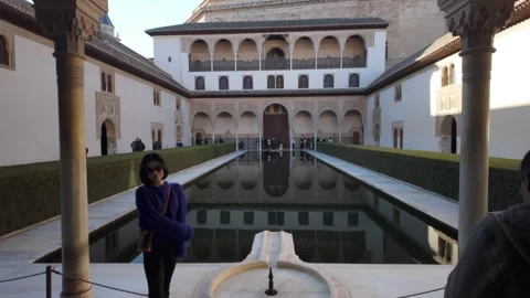Tourists posing infront of pond on a sunny day, Alhambra, Andalusia, Spain - 4K Stock Footage 331689971