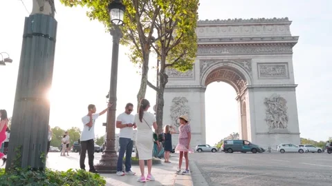 Tourists Posing for Photos at Arc de Triomphe in Paris during Sunset: Stock Footage 249670992