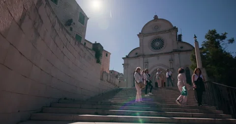 Tourists posing on steps in front of Saint James Cathedral in Sibenik Croatia Video stock 336492571