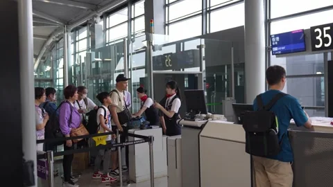 Tourists queing for boarding airplane at checking counter - 4k footage Video stock 245553977