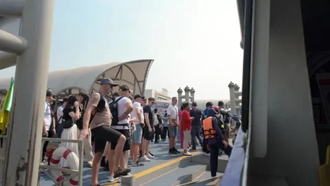 Tourists queue to board a passenger ferry on Bangkok's Chao Phraya River Stock Footage 340544369
