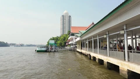 Tourists queue to board a passenger ferry on Bangkok's Chao Phraya River Stock Footage 340545590