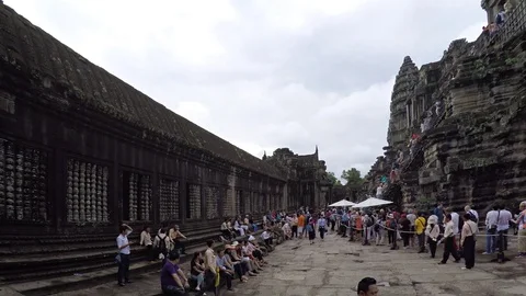 Tourists in a queue to enter an ancient building at Angkor Wat Stock Footage 74618275