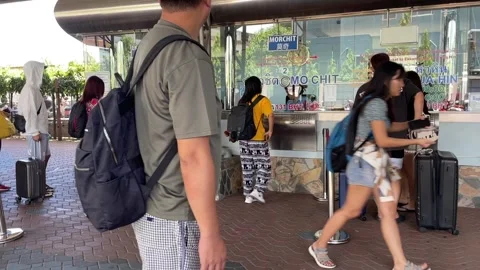 Tourists queue at Pattaya bus station to buy tickets at counters Stock Footage 251943659