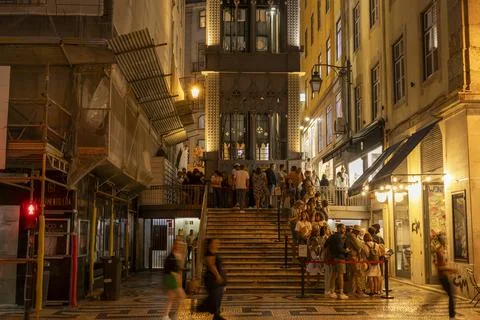 Tourists queue to Santa Justa Elevator at evening. Lisbon city, Portugal. Stock Photos