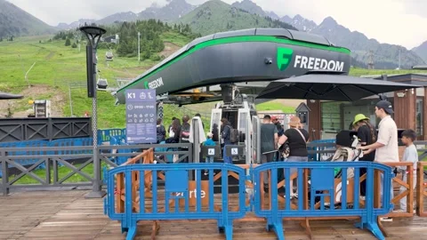 Tourists queueing at Freedom cable car station in Shymbulak mountain resort Stock Footage 345447494