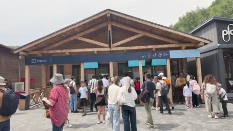 Tourists queueing at Freedom cable car station in Shymbulak mountain resort Stock Footage 345448643