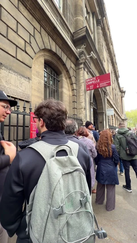 Tourists queueing in line at Sainte Chapelle in Paris Stock Footage 339812750