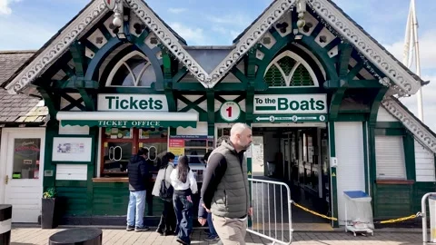 Tourists queueing at the traditional ticket office for boat trips on Lake Stock Footage 333640005