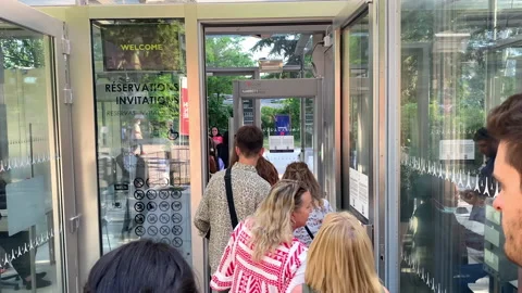Tourists queuing to go through the security control check at the Eiffel Tower Stock Footage 196151105
