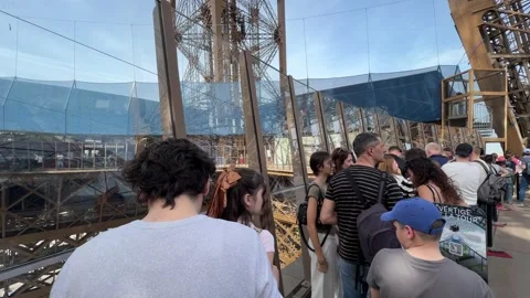 Tourists queuing for Vertige de la Tour at Eiffel Tower Stock Footage 334107586