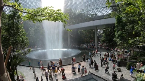 Tourists at Rain Vortex waterfall, Jewel Changi Airport, Singapore Stock-Footage 110797170