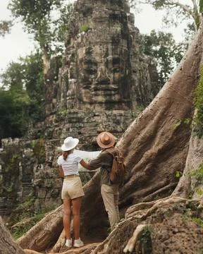 Tourists Reading Map At Bayon Face Tower, Angkor Cambodia Adventure Stock Photos