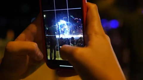 Tourists records pyrotechnic performance with flying sparks Stock Footage 285389148