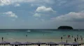 Tourists relax on a famous beach, summer vacation, people in the water, swim HD Footage