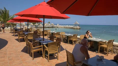 Tourists at a restaurant on the beach Stock Footage 87845467