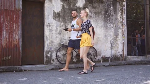 Tourists in a rickshaw, passing a 3D mural in George Town. Stock Footage 77424586