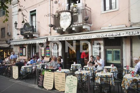 Tourists at a sidewalk cafe, Taormina, Province of Messina, Sicily, Italy Stock Photos