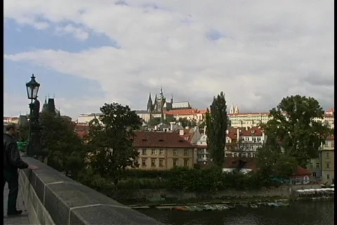 Tourists sightsee in Prague along a road that overlooks the city. Stock Footage