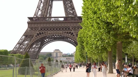 Tourists Sightseeing at the Eiffel Tower in Champ de Mars Paris Stock Footage 334652919