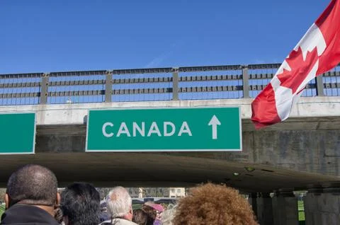 Tourists sit on an upper deck of bus tour heading towards Canada Stock Photos