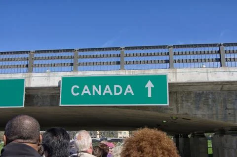 Tourists sit on an upper deck of bus tour heading towards Canada 스톡 사진