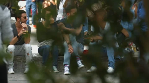 Tourists sitting down, drinking and talking in a square in Stuttgart Stock Footage 55282447