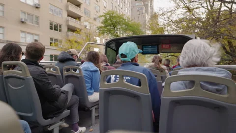 Tourists sitting on open top double decker bus during sightseeing tour Stock Footage 332697482