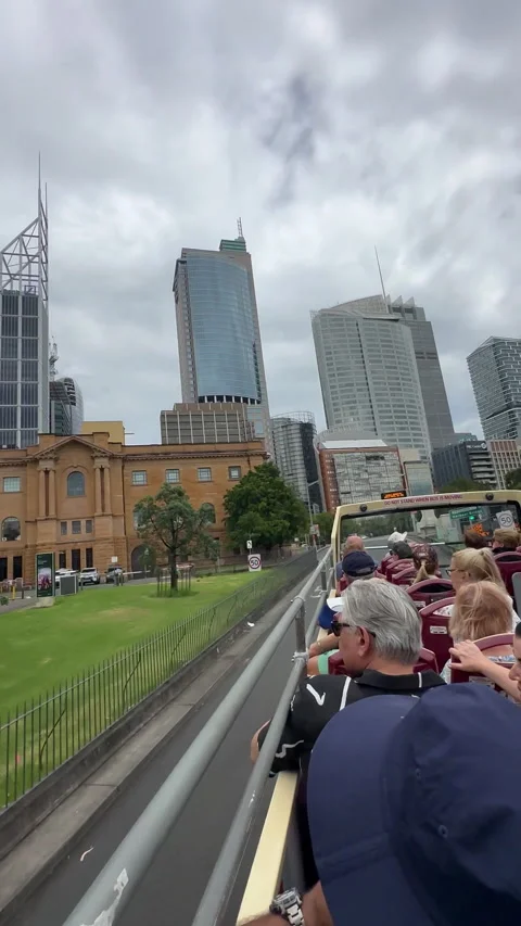 Tourists sitting on an open-top sightseeing bus Stock Footage 313157255