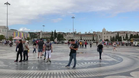 Tourists on the square with the image of Compass Rose &amp; map of the world. Lisbon Stock Footage 133560373