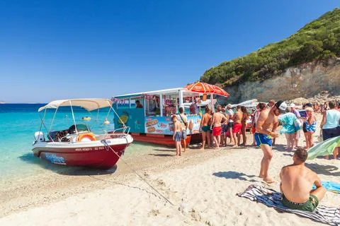 Tourists stand in a queue to an Ice Cream shop Stock Photos