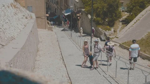 Tourists stand resting on a paved path on holiday Stock Footage 88903578
