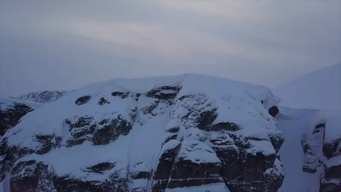 Tourists stand on sharp mountain peak covered with snow Video stock 112532628