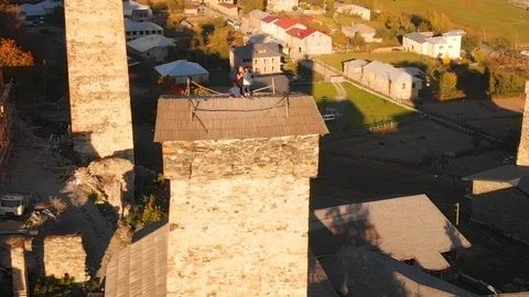 Tourists Standing atop Ancient Svan Defensive Tower in Remote Town of Mestia 库存影片 100137775