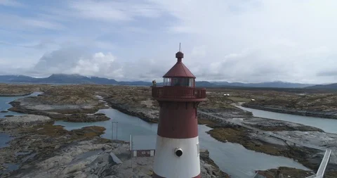 Tourists standing on the lighthouse at seacoast Stock Footage 85841589