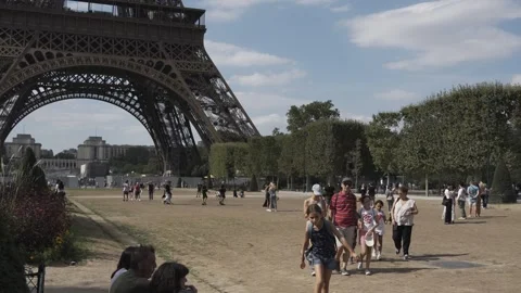 Tourists stroll under the great Eiffel Tower. 動画素材 249263632