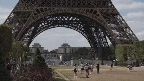 Tourists stroll under the great Eiffel Tower. Stock Footage 249263659