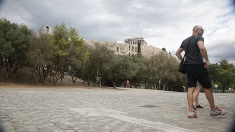 Tourists strolling by the Parthenon during a cloudy day Stock Footage 87555088